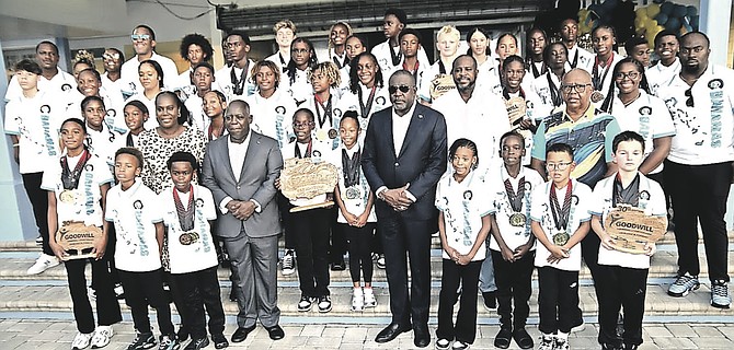Prime Minister Philip Davis and Minister of Youth Sports Mario Bowleg greet Team Bahamas' swimmers on their arrival August 18th,2026.
Photos: Nikia Charlton