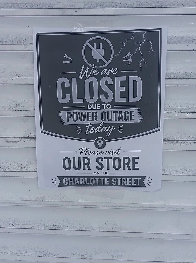 CLOSED notice on a business in Downtown, Nassau.