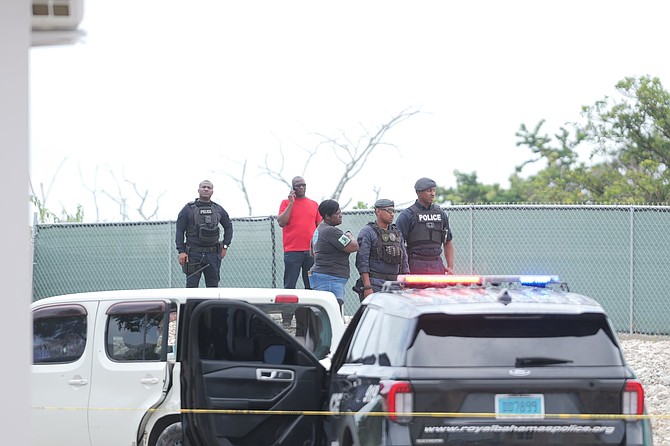 Police officers investigate an area following a shooting at Gladstone Road on August 22, 2026.