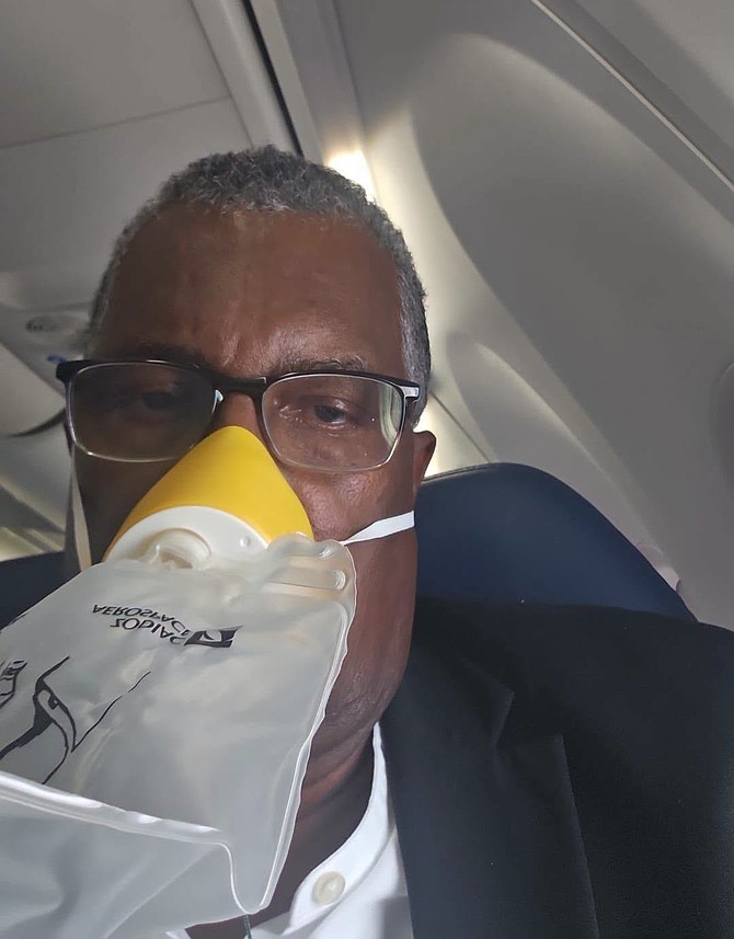 Foreign Affairs minister Fred Mitchell with his oxygen mask on aboard a Delta airlines flight from Atlanta to Nassau on august 21, 2026.