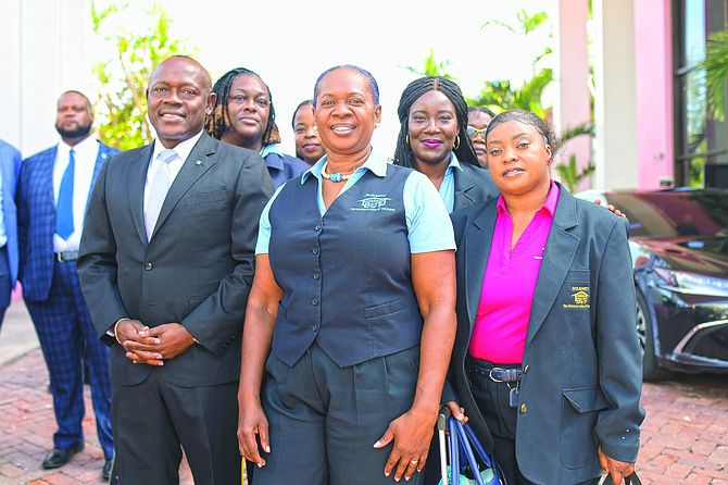 BUT president Belinda Wilson (centre) and Education Minister Chester Cooper pose for a picture after securing a new pay and benefits agreement for teachers.Photo: Shawn Hanna