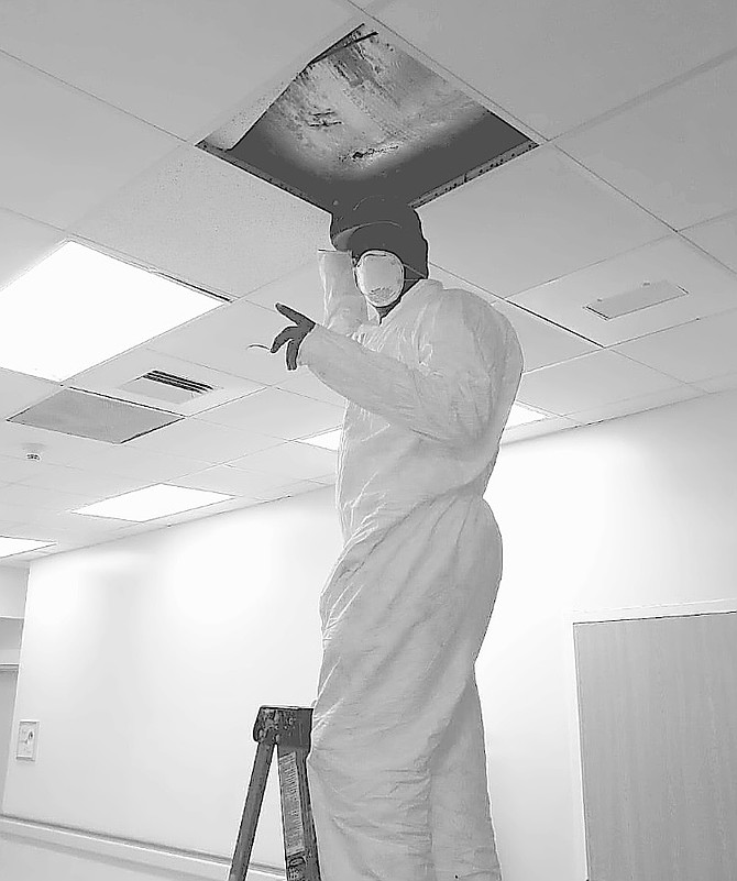 A WORKER conducts repairs to the air-conditioning system at the Marsh Harbour Healthcare Centre.