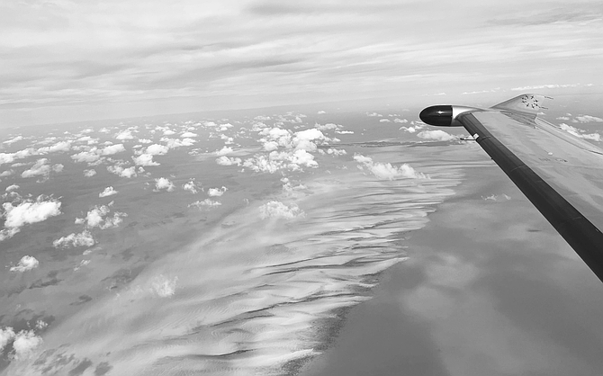AN AIRLINE flies over the waters of The Bahamas.