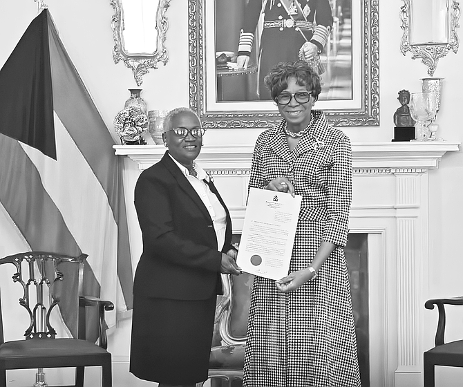 DONNA Newton receives her appointment as Information Commissioner from Gover Genreal Dame Cynthia ‘Mother’ Pratt.