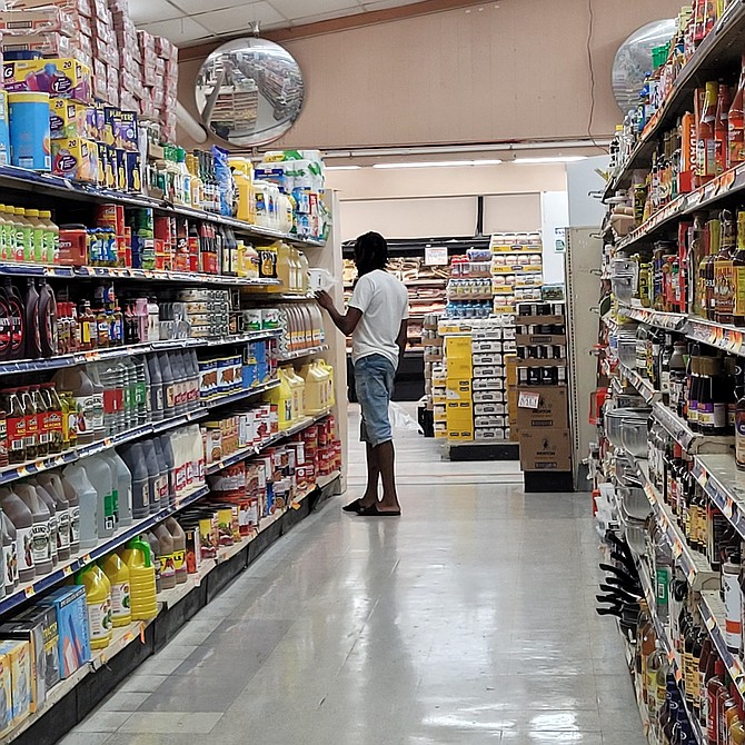 A CUSTOMER shops for groceries at a supermarket in New Providence. Photo: Nikia Charlton