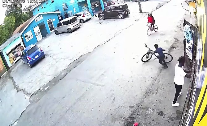SCREEN capture from a security camera shows the boy taking a bicycle.