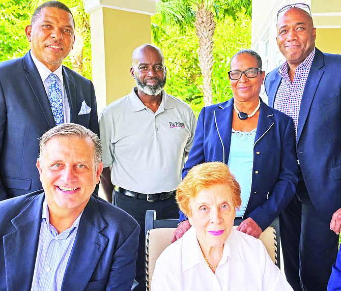 Mrs Poitier (second from right standing) with The Rt Hon Eileen Carron, Robert Dupuch-Carron and (back from left) Lyrone Burrows, President and CEO of Bahamas First Alert Project Manager Limited (BFAPM), Rhett Storr, Tribune Chief Financial Officer and Paul Major, VP Governmental Affairs, BACSWN.