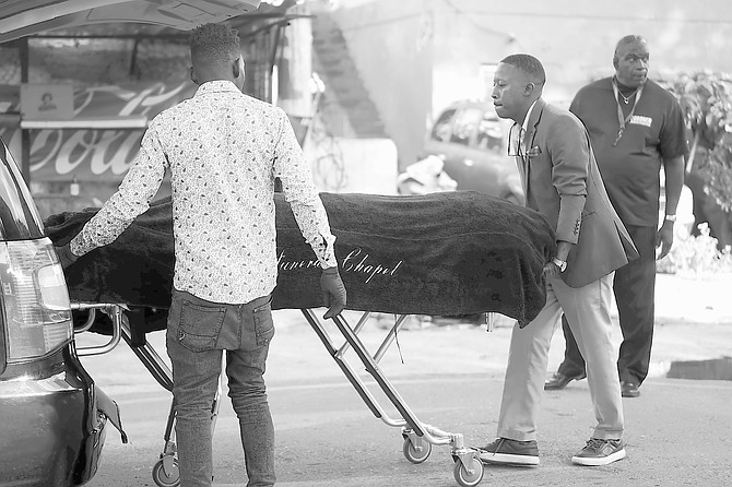 A man’s body is taken from the scene on Lincoln Blvd where he was shot dead yesterday. Photos: Chappell Whyms Jr