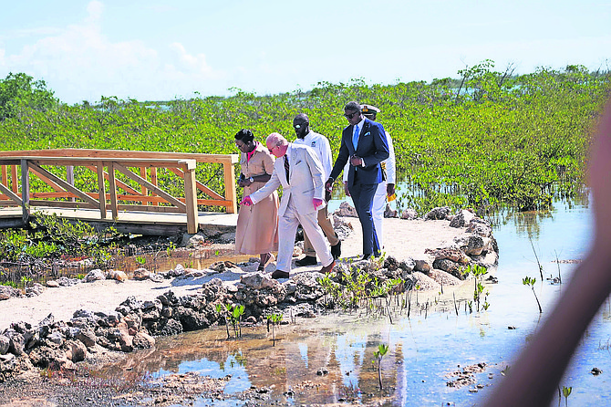 BNT xecutive director Lakeshia Anderson-Rolle walks alongside King Charles III during a tour of Bonefish Pond yesterday, where she said the king asked many questions.
Photo: Nikia Charlton