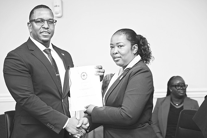EXECUTIVE Chairman of the Bahamas Public Parks and Public Beaches Authority is Jamahl Strachan and Bahamas Communications and Public Officers Union (BCPOU) president Sherry Benjamin hold the industrial agreement signed yesterday.